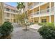Charming courtyard featuring lush landscaping and multiple story condo balconies at 701 Mirror Lake N Dr # 119, St Petersburg, FL 33701