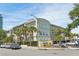 Beautiful condominium building with lush landscaping and mature palm trees at 701 Mirror Lake N Dr # 119, St Petersburg, FL 33701