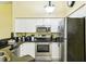 Modern kitchen featuring stainless steel appliances and black countertops at 701 Mirror Lake N Dr # 119, St Petersburg, FL 33701