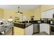 Kitchen with sleek countertops, stainless steel appliances and an open view of the living area at 701 Mirror Lake N Dr # 119, St Petersburg, FL 33701