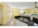 Open-concept living room area has a modern sink with stylish countertops and walls at 701 Mirror Lake N Dr # 119, St Petersburg, FL 33701