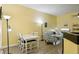 Living room with a white dining table, sofa, a ceiling fan and wood-look floors at 701 Mirror Lake N Dr # 119, St Petersburg, FL 33701