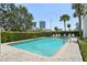 Relaxing community pool surrounded by lush greenery and palm trees at 701 Mirror Lake N Dr # 119, St Petersburg, FL 33701