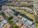 Beautiful aerial view of a neighborhood featuring a golf course and pond at 7441 Trovita Rd, Land O Lakes, FL 34637