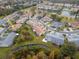 Aerial view of homes with pond view and lush landscaping in a serene community at 7441 Trovita Rd, Land O Lakes, FL 34637