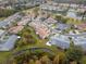 Aerial view of homes with pond view and lush landscaping in a serene community at 7441 Trovita Rd, Land O Lakes, FL 34637