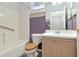 This bathroom offers a tub with shower, single sink vanity and wood toilet seat at 7441 Trovita Rd, Land O Lakes, FL 34637