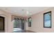 Bedroom featuring hardwood floors, a fan, and sliding glass doors to the patio at 7441 Trovita Rd, Land O Lakes, FL 34637