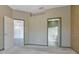 Bedroom featuring doorways to the hallway and a bathroom with a glass shower at 7441 Trovita Rd, Land O Lakes, FL 34637