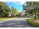 Inviting clubhouse entrance with professionally landscaped grounds, complemented by well-maintained walkways at 7441 Trovita Rd, Land O Lakes, FL 34637