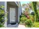 View of the front door with manicured shrubs, plantings and stone accents at 7441 Trovita Rd, Land O Lakes, FL 34637