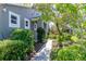 Sidewalk leading to the front door through lush garden at 7441 Trovita Rd, Land O Lakes, FL 34637