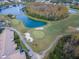 Aerial view of the community's pristine golf course, showcasing manicured greens and scenic water features at 7441 Trovita Rd, Land O Lakes, FL 34637