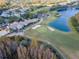 Aerial shot displaying a scenic golf course surrounded by mature trees and lush landscaping at 7441 Trovita Rd, Land O Lakes, FL 34637
