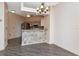 Open kitchen view with a breakfast bar and modern chandelier, flowing into the dining area at 7441 Trovita Rd, Land O Lakes, FL 34637