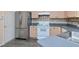 Modern kitchen featuring stainless steel refrigerator, white oven, tile backsplash and light wood cabinets at 7441 Trovita Rd, Land O Lakes, FL 34637