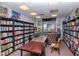 Cozy library with extensive bookshelves, tables, and comfortable seating, ideal for reading and study at 7441 Trovita Rd, Land O Lakes, FL 34637