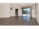 Spacious living room with sliding glass door to a screened lanai and wood-look vinyl floors at 7441 Trovita Rd, Land O Lakes, FL 34637