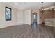 Spacious living room featuring laminate floors, neutral walls, and open layout to kitchen at 7441 Trovita Rd, Land O Lakes, FL 34637