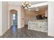 Open-concept floorplan with kitchen view from the living room area with laminate flooring at 7441 Trovita Rd, Land O Lakes, FL 34637