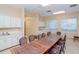Functional meeting room equipped with a large table and cabinets at 7441 Trovita Rd, Land O Lakes, FL 34637