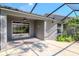 Enclosed patio featuring concrete flooring, a garden view, and access to the home's interior at 7441 Trovita Rd, Land O Lakes, FL 34637