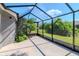 Enclosed patio featuring concrete flooring and a beautiful view of the well-maintained backyard and foliage at 7441 Trovita Rd, Land O Lakes, FL 34637