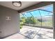 Covered and screened lanai overlooking a backyard with mature trees at 7441 Trovita Rd, Land O Lakes, FL 34637