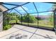 Screened lanai overlooking a landscaped backyard with mature trees at 7441 Trovita Rd, Land O Lakes, FL 34637