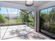 Screened lanai overlooking a landscaped backyard at 7441 Trovita Rd, Land O Lakes, FL 34637