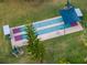 Aerial view of shuffleboard courts with shading, offering a fun recreational activity in a lush setting at 7441 Trovita Rd, Land O Lakes, FL 34637