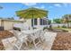 Backyard with patio, table and chairs, and a landscaped fire pit area at 783 41St Ne Ave, St Petersburg, FL 33703