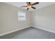 Well-lit bedroom featuring neutral colors, plush carpeting, and a modern ceiling fan at 783 41St Ne Ave, St Petersburg, FL 33703