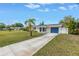 Charming single-story home with a well-manicured lawn, blue garage door, and inviting curb appeal at 783 41St Ne Ave, St Petersburg, FL 33703