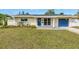 Charming single-story home with blue door and garage and freshly cut lawn at 783 41St Ne Ave, St Petersburg, FL 33703