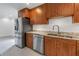 Open kitchen with stainless steel appliances and wooden cabinetry at 783 41St Ne Ave, St Petersburg, FL 33703