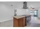 Kitchen island with cooktop and modern vent hood at 783 41St Ne Ave, St Petersburg, FL 33703
