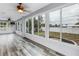 Bright sunroom features wood-look floors and multiple windows overlooking the backyard at 783 41St Ne Ave, St Petersburg, FL 33703