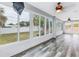 Bright sunroom features wood-look floors and multiple windows overlooking the backyard at 783 41St Ne Ave, St Petersburg, FL 33703