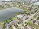 Gorgeous aerial view of a Primary-planned community featuring a scenic lake and neighborhood pool at 810 Fern Leaf Dr, Ruskin, FL 33570