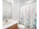 Bathroom with a shower/tub, vanity, and floral shower curtain at 810 Fern Leaf Dr, Ruskin, FL 33570