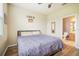 Bedroom with ensuite bathroom, hardwood floors, ceiling fan, and double bed at 810 Fern Leaf Dr, Ruskin, FL 33570
