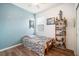 Small bedroom with wooden floors, ceiling fan, window, and shelf at 810 Fern Leaf Dr, Ruskin, FL 33570