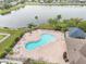 Relaxing community pool with ample seating, perfect for enjoying sunny days and the lakeside views at 810 Fern Leaf Dr, Ruskin, FL 33570