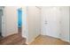 Tiled and hardwood hallway showing the front entrance and another room at 810 Fern Leaf Dr, Ruskin, FL 33570