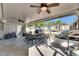 Relaxing screened-in porch with ceiling fans, an outdoor dining table, and views of the backyard at 8805 Cobb Rd, Riverview, FL 33578