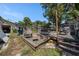Spacious backyard featuring a deck, lush trees and partial view of the home exterior at 910 E North Bay St, Tampa, FL 33603