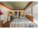 Bedroom featuring multiple windows, wood floors, a ceiling fan, and decorative trim at 910 E North Bay St, Tampa, FL 33603