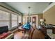Sunlit dining area with wood floors, vintage accents, and a view of the living spaces at 910 E North Bay St, Tampa, FL 33603