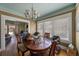 Bright dining room with a vintage chandelier, large windows, and views into the living room at 910 E North Bay St, Tampa, FL 33603